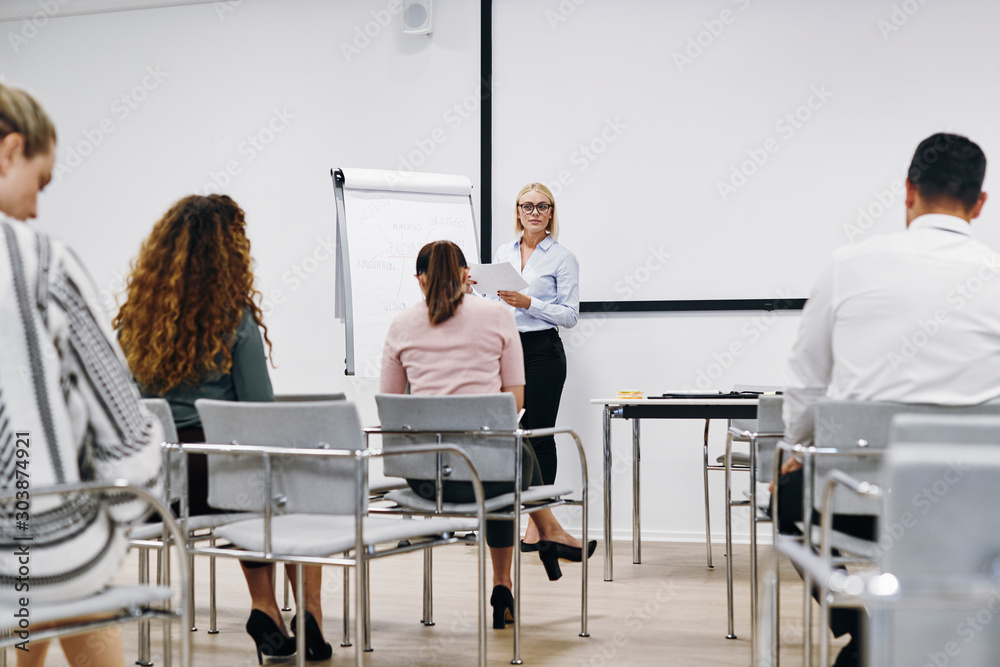 Manager giving a presentation to her office team