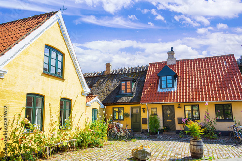 Fototapeta Naklejka Na Ścianę i Meble -  Small streets with beautiful, yellow old houses. Traditional Scandinavian houses.Dragor, Denmark. Architecture.