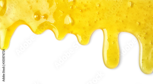 Flowing yellow slime on white background. Antistress toy