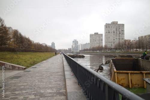 Cargo barges with land on a city river