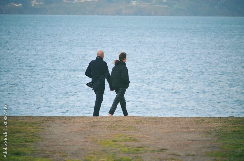 Couple walking on the ocean shores