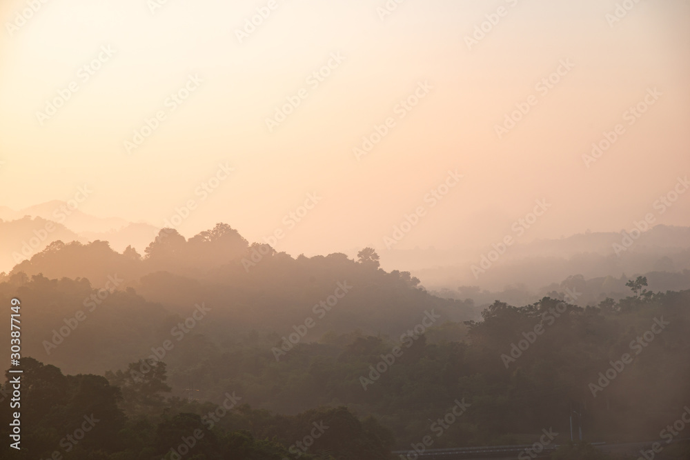 yellow bright multi layer mountain in morning view with mist