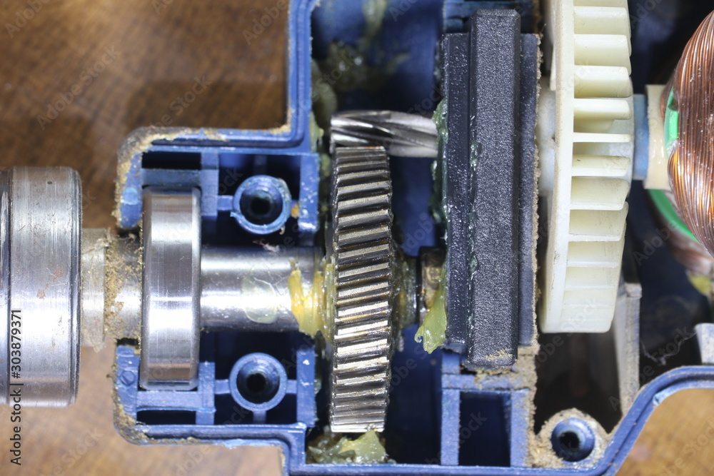 Metal gear inside an electric machine. Mechanism of an electric drill. Metal gear inside an electric machine. Mechanism of an electric drill.