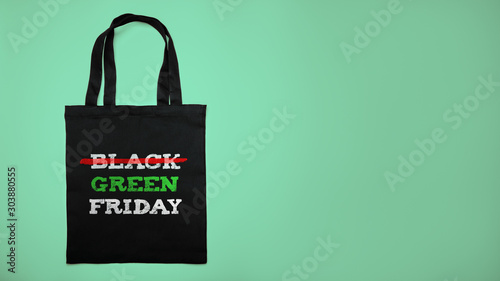 Green black friday. Cotton shopping bag with text on green background.