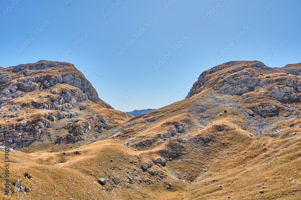 Rocky mountains covered with autumn meadow against the blue sky Rocky mountains covered with autumn meadow against the blue sky