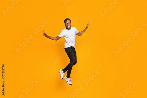 Joyful Afro Guy Jumping In Air Having Fun  Studio Shot