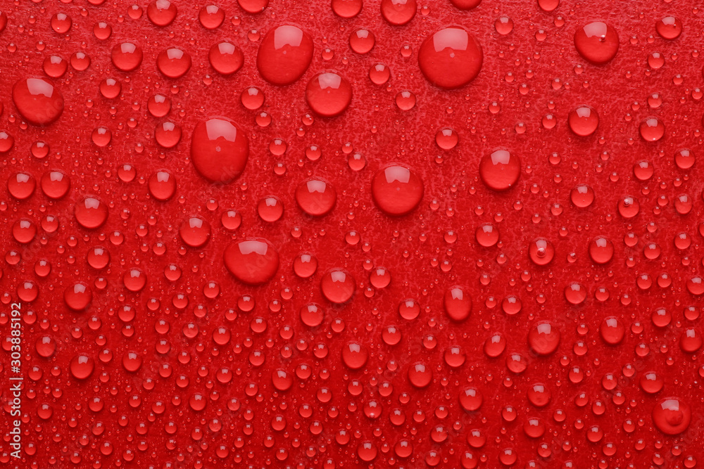 Water drops on red background, top view Water drops on red background, top view