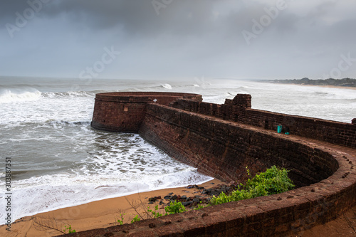 Old ruins of Fort Aguada on the seashores of Goa with sky and clouds