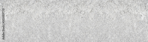 Light grey shabby concrete wall wide texture. Rough weathered cement surface long white backdrop. Large whitewashed background