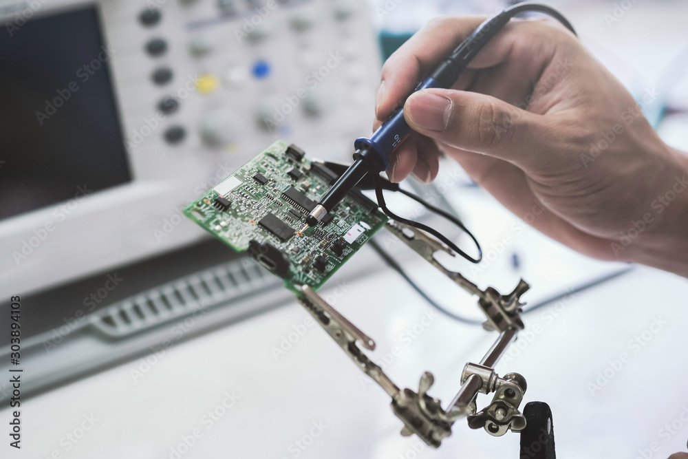 Φωτογραφία Close up of the hand men hold tool repairs electronics manufacturing Services, Manual Assembly Of Circuit Board Soldering