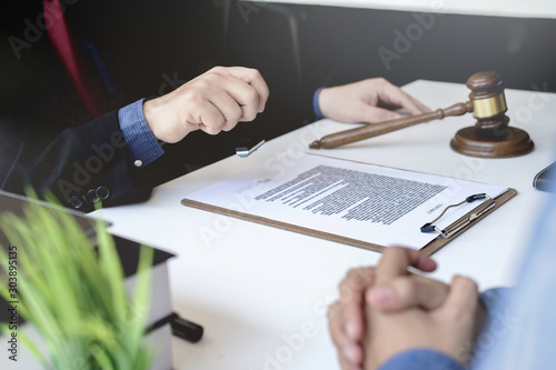 Justice lawyer meeting with contract papers and Judge gavel on tabel in courtroom. Attorney working in courtroom. Justice and law, attorney, court judge concept.