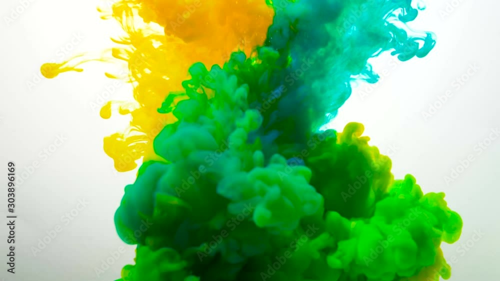mixed yellow and blue liquid ink clouds form bright green