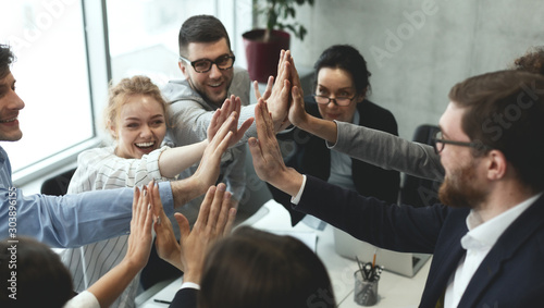Quadro em tela Motivated business team giving group high five
