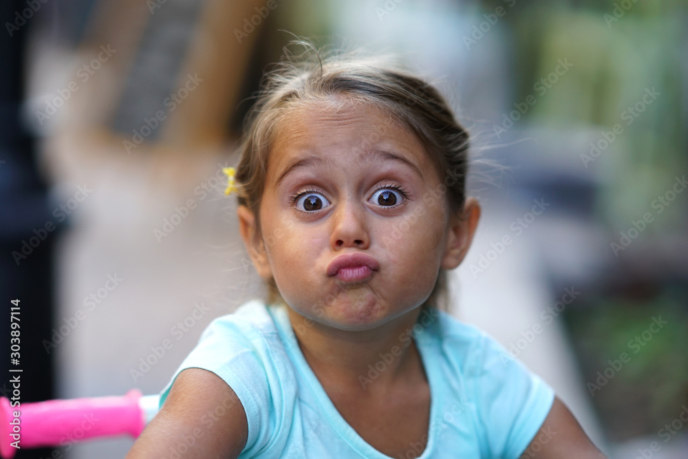 Portrait of 4 year old girl that makes the funny face Portrait of 4 year old girl that makes the funny face