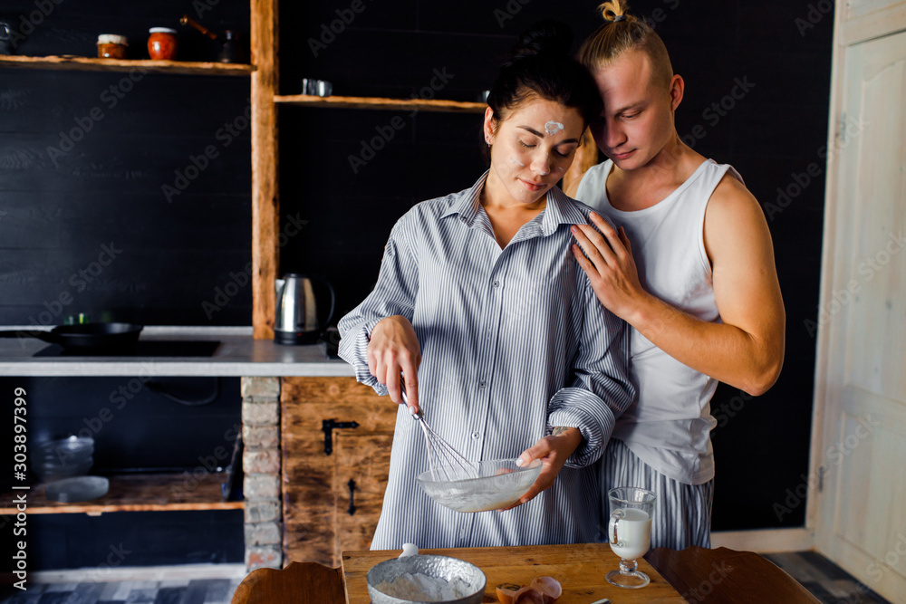 Couple preparing breakfast at home. The girl and the guy live together.