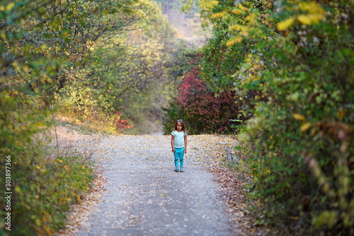 a 4-year-old girl in an autumn forest © jekatarinka