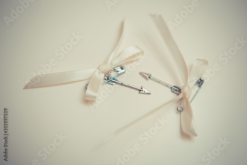 Silver arrows of love with bows.
