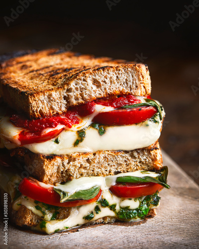 Fotografie Caprese grilled sandwich on wooden board