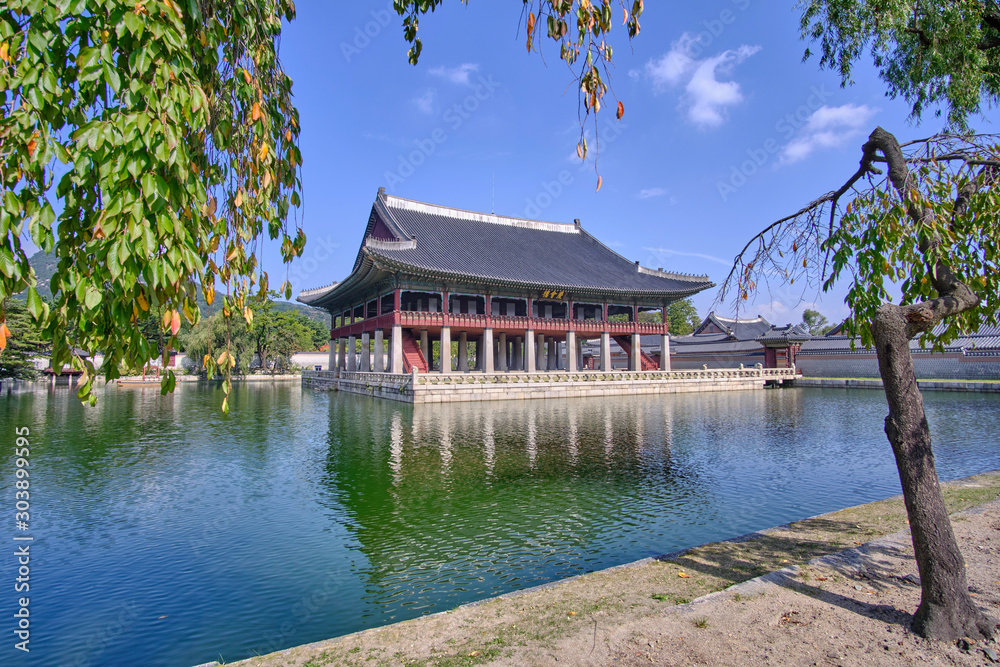 Fototapeta premium Scenic view of beautiful old building on water in palace in capital of Republic of Korea Seoul. Beautiful summer sunny look of construction in asian style in largest city of South Korea.