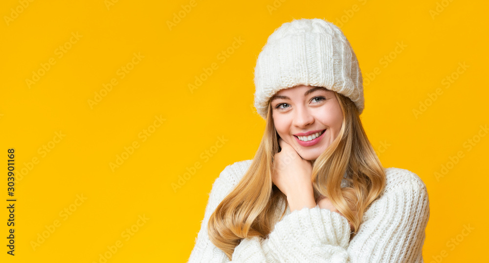 Portrait of attractive smiling girl in white knitted winter hat Portrait of attractive smiling girl in white knitted winter hat