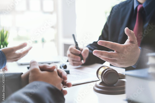 Justice lawyer meeting with contract papers and Judge gavel on tabel in courtroom. Attorney working in courtroom. Justice and law, attorney, court judge concept.