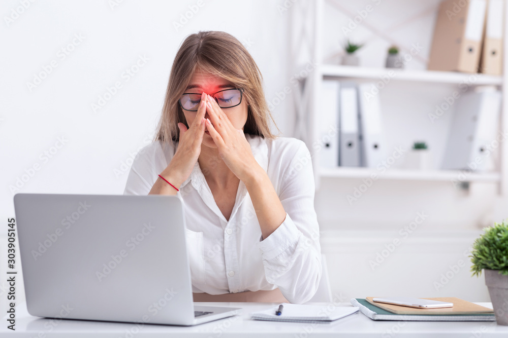 Sad Businesswoman Suffering From Sinus Pain Sitting At Workplace Sad Businesswoman Suffering From Sinus Pain Sitting At Workplace