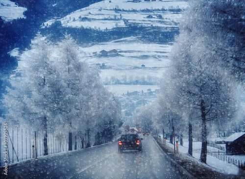 Car traffic on a mountain road during a snow storm on the Austrian Alps