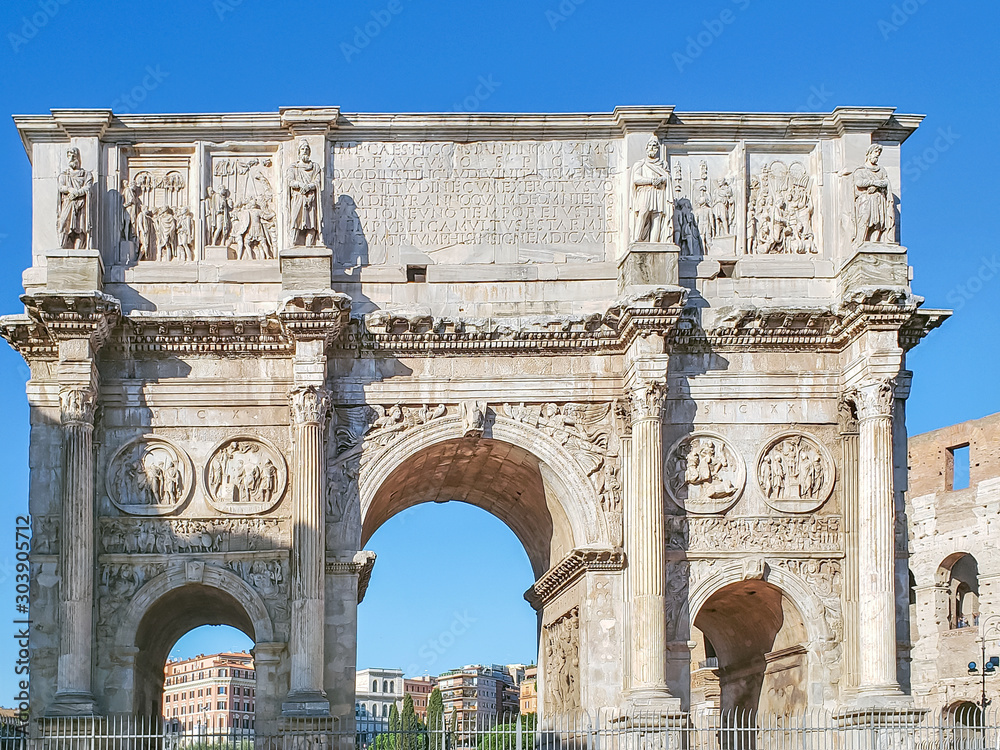 A fragment of the arch of Constantine at the iconic Colosseum in Rome, Italy.