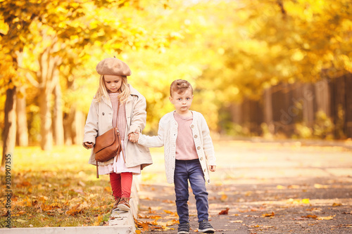 Cute little children walking in autumn park
