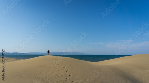photographer walking through a desert