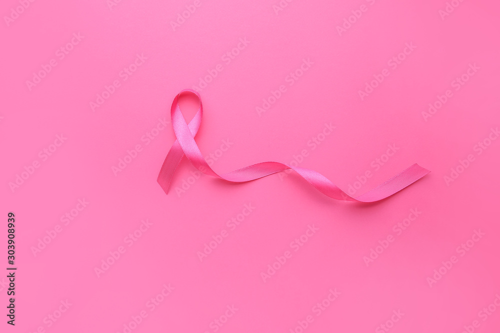 Pink ribbon on color background. Cancer awareness concept