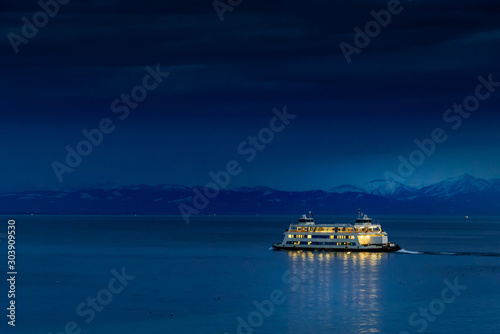 A car ferry by night at lake constance