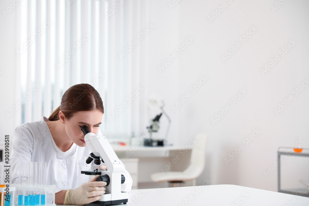 Scientist using modern microscope at table. Medical research