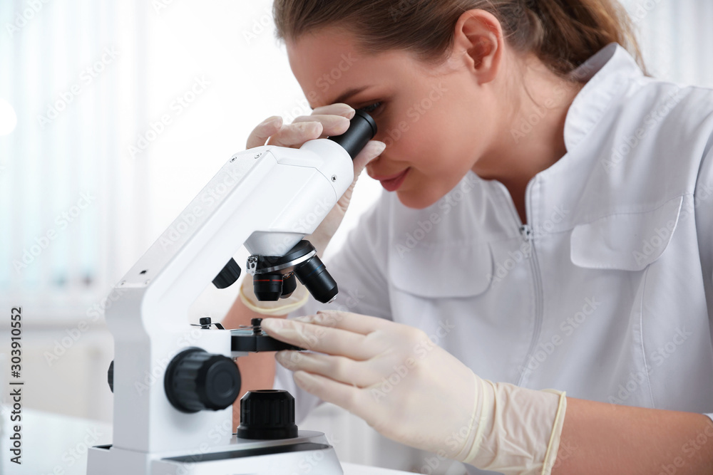 Scientist using modern microscope at table, closeup. Medical research Scientist using modern microscope at table, closeup. Medical research