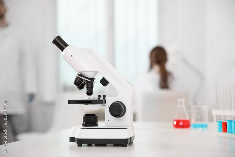 Modern microscope on white table in laboratory. Medical research Modern microscope on white table in laboratory. Medical research