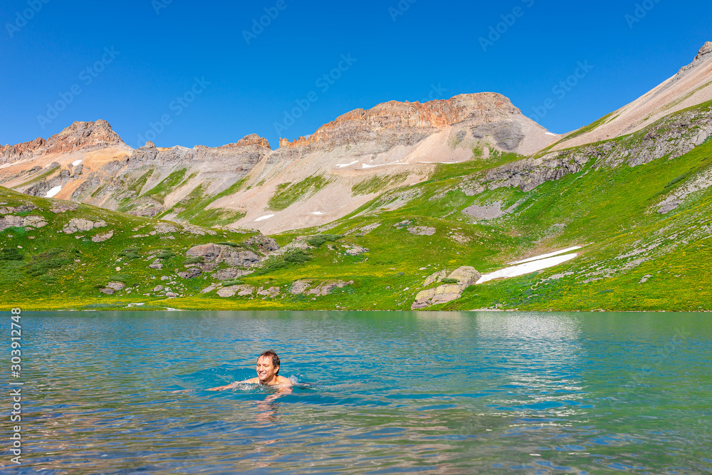 Φωτογραφία Young happy man swimming in cold colorful water of Ice Lake on famous trail in S