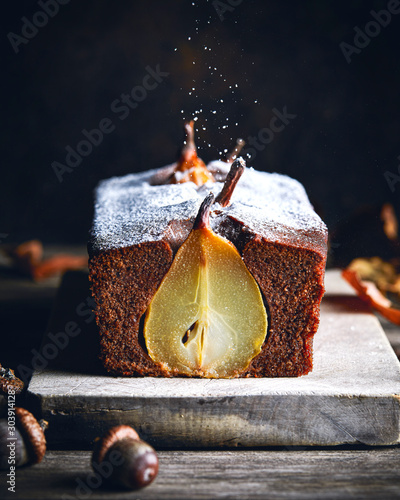 Pear and chocolate plumcake on wooden board photo