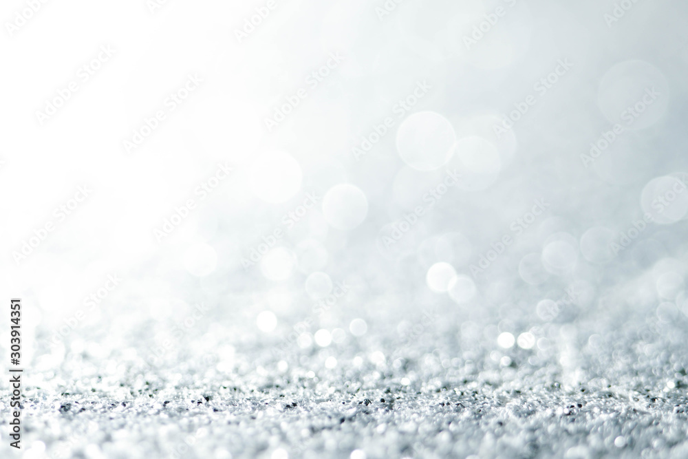 Silver Sparkling Lights Festive background with texture. Abstract Christmas twinkled bright bokeh defocused and Falling stars. Winter Card or invitation Silver Sparkling Lights Festive background with texture. Abstract Christmas twinkled bright bokeh defocused and Falling stars. Winter Card or invitation