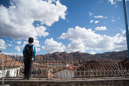 boy looking the clouds in Cuzco, Peru