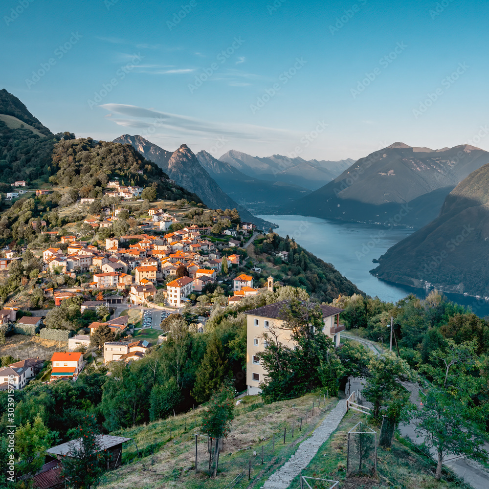 View of Swiss village bre sopra and Lugano Lake before sunset from Monte Bre in Lugano