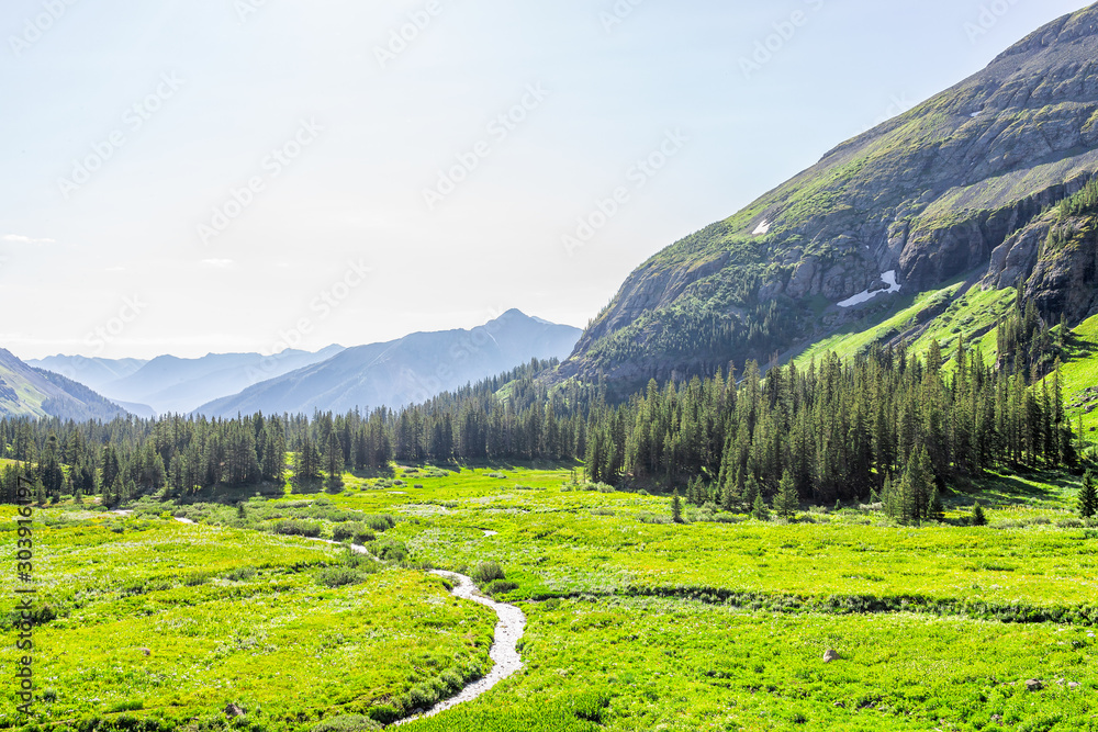 High angle view of river flowing through meadow field on trail to Ice lake near Silverton, Colorado in August 2019 summer