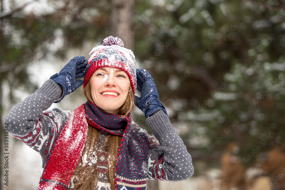 Happy beautiful woman having fun with snow outdoors in winter scenery Happy beautiful woman having fun with snow outdoors in winter scenery