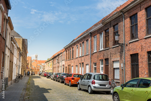 Row of cars on cozy street in old town, Europe