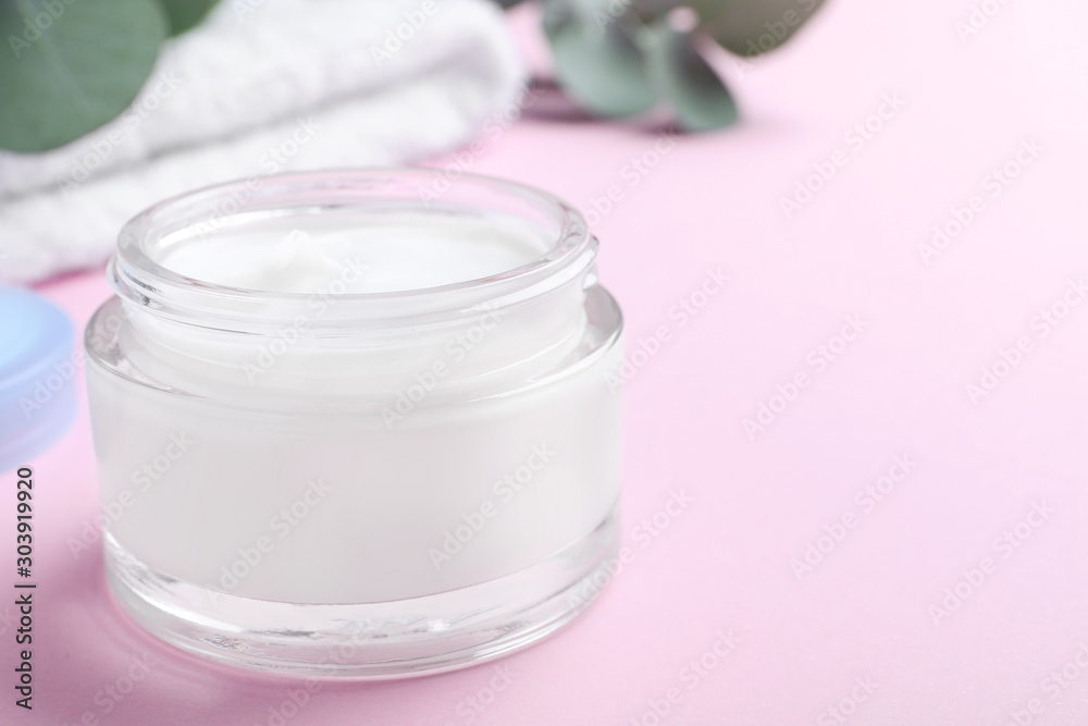 Open jar of cream on pink background, closeup. Space for text Open jar of cream on pink background, closeup. Space for text