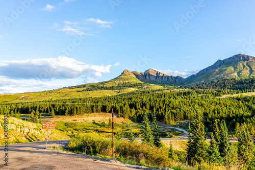 Sunrise in rocky San Juan mountains in Silverton, Colorado in 2019 summer morning with meadow valley and sign for little molas lake photo