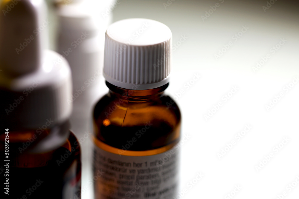 A close up view of three isolated Liquid Medicine Bottles with white background, Medical bottle glass isolated on white background, brown medicine container bottles A close up view of three isolated Liquid Medicine Bottles with white background, Medical bottle glass isolated on white background, brown medicine container bottles