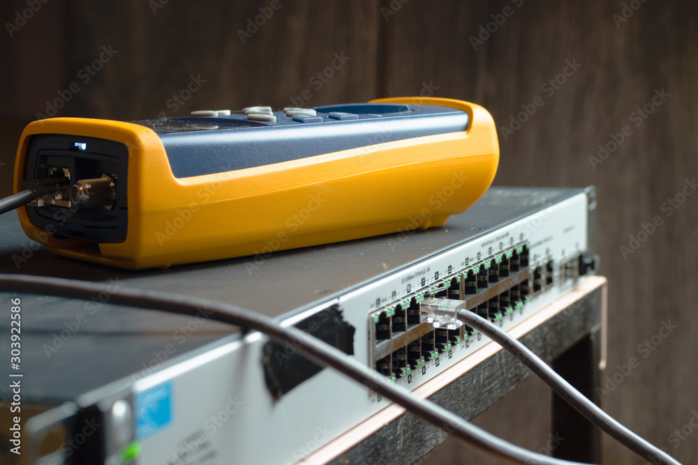 Computer data network switch ports with Ethernet cables and cable testing equipment Computer data network switch ports with Ethernet cables and cable testing equipment