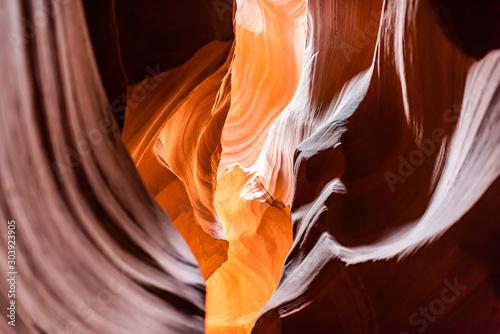 Abstract shapes of yellow orange red shadows and light at upper Antelope slot canyon with wave rock sandstone in Page, Arizona