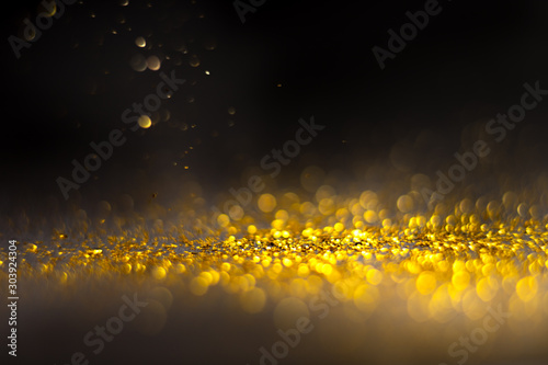 Glitter gold grunge blur abstract background. Lights twinkly dust and christmas texture