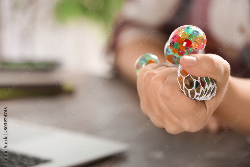 Woman squeezing colorful slime in office, closeup. Antistress toy Woman squeezing colorful slime in office, closeup. Antistress toy